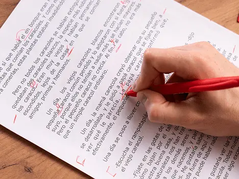 Student marking english grammar corrections on paper during ACT online coaching